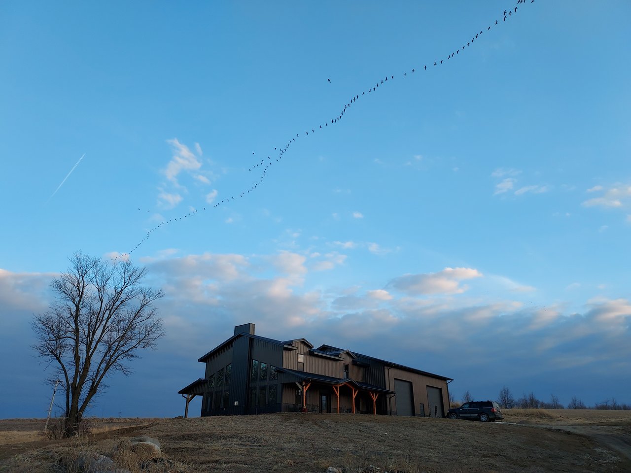 Custom home beneath an expansive blue evening sky